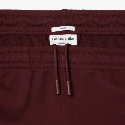Trousers*Lacoste Tapered Leg Sweatpants in red maroon